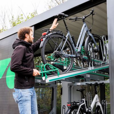 Fahrradparken in Berlin: Mann stellt Fahrrad in gesicherter Fahrradabstellanlage ab – Projektbereich Fahrradparken