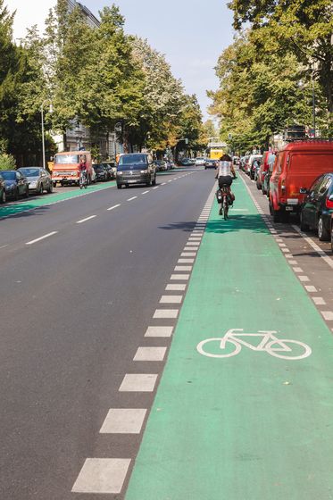 Radfahrerin auf einem grünbeschichteten Schutzstreifen