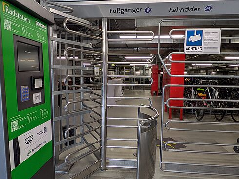 Eingangsbereich zum gesicherten Fahrradparken mit Terminal und Drehkreuz