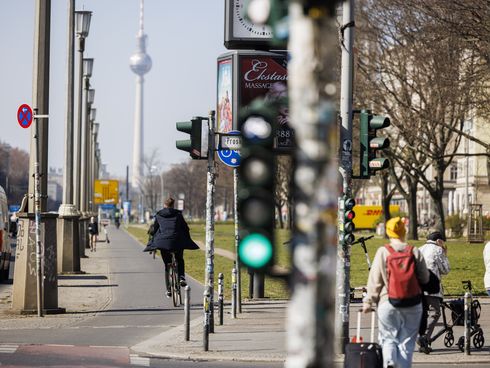 Eine Fahrradampel zeigt Grün, im Hintergrund fährt ein Radfahrer auf den Fernsehturm zu.