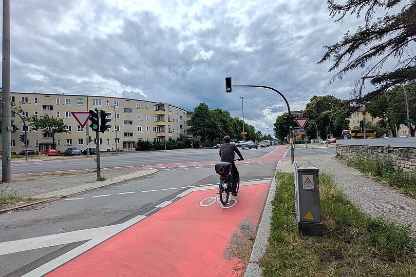 rotbeschichteter Radfahrstreifen an Kreuzung mit Radfahrer