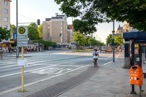 Radfahrende hält an roter Ampel auf schmalem Hochboardradweg Residenzstraße