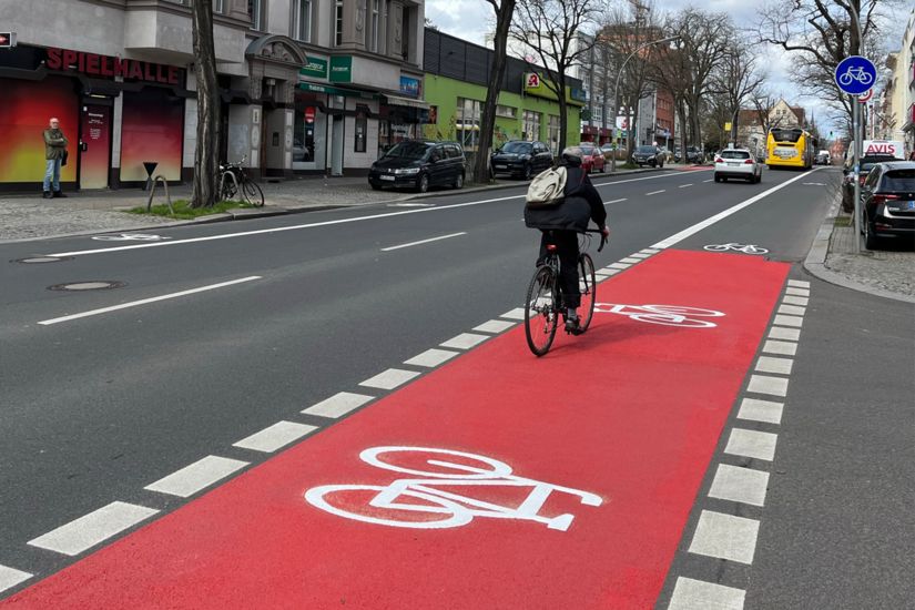 Radfahrender auf rotmarkiertem Radfahrstreifen.